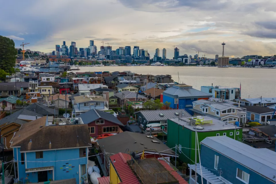 View of downtown Seattle across a body of water with colorful houses in the foreground
